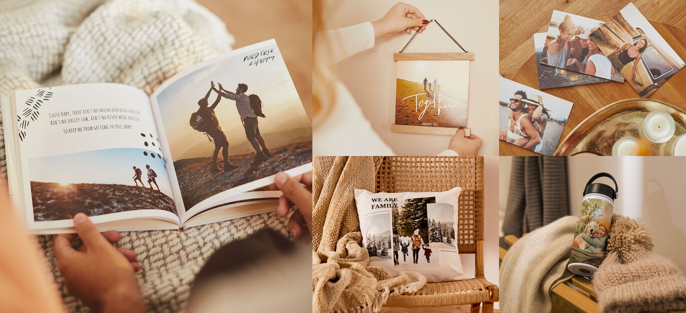 Una persona sfoglia un CEWE FOTOBOOK con foto di viaggi e amici. Accanto si vede un quadro e varie cartoline.